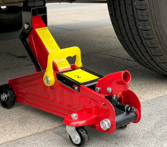 出租車突然爆胎，加油站員工用臥式千斤頂幫其換胎